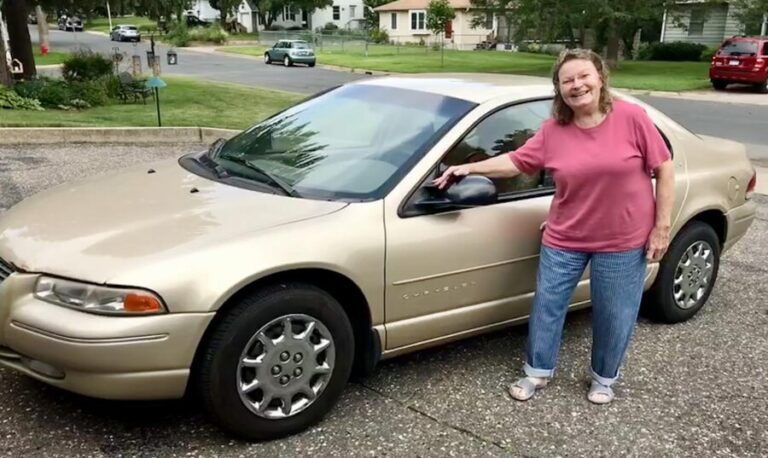 woman smiling with her car